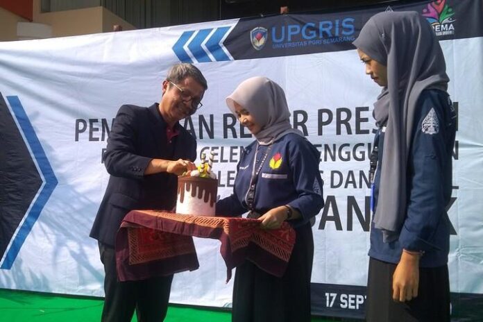 Rektor UPGRIS Muhdi secara simbolis memasukkan uang dalam celengan sebagai penanda gerakan menabung, Selasa (17/9).