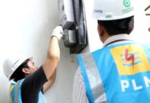 Petugas dari PLN memeriksa sambungan meteran