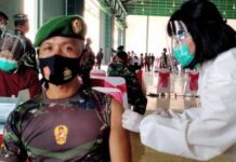 Seorang anggota TNI mendapat vaksinasi