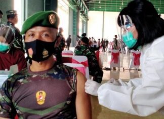 Seorang anggota TNI mendapat vaksinasi