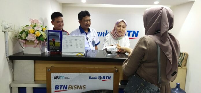 Wakil Kepala Kanwil Bank BTN Jateng-DIY Bambang Prasetyo berbincang dengan nasabah di Outlet Bank BTN di Pasar Peterongan, Semarang, Jawa Tengah,