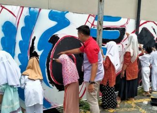 Kegiatan mural yang diadakan JNE Semarang